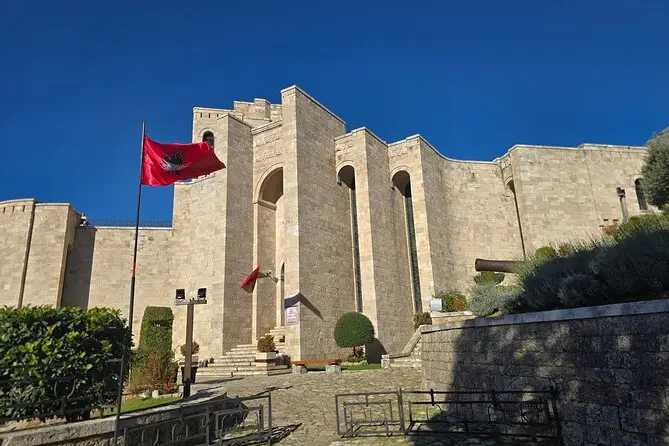 http://Front%20view%20of%20the%20National%20Museum%20of%20Skanderbeg%20in%20Kruja,%20Albania,%20with%20Albanian%20flags%20and%20historic%20stone%20architecture.
